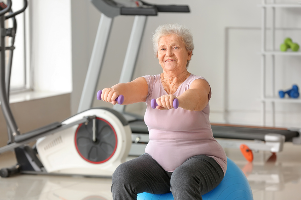 Elderly Woman Exercising in Gym